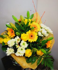 Citrussy tones for this bright and beautiful hand-tied bouquet