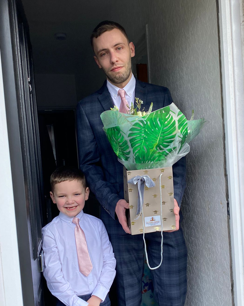 Daniel, our Wedding of the Week winners, posing with a beautiful bouquet of flowers from The Flower Fountain.
