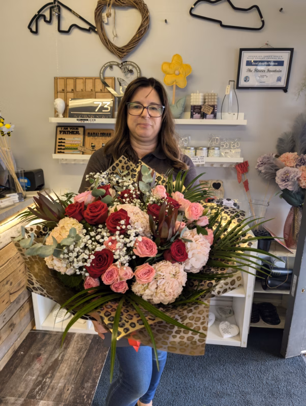 Rhiann Jones from The Flower Fountain Florists holding a fresh flower bouquet in Stoke-on-Trent