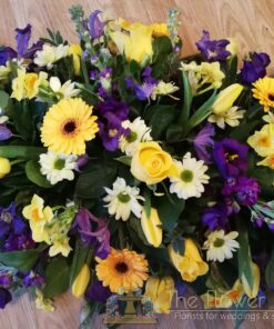 Funeral_Tributes - purple-yellow-and-white-casket-spray